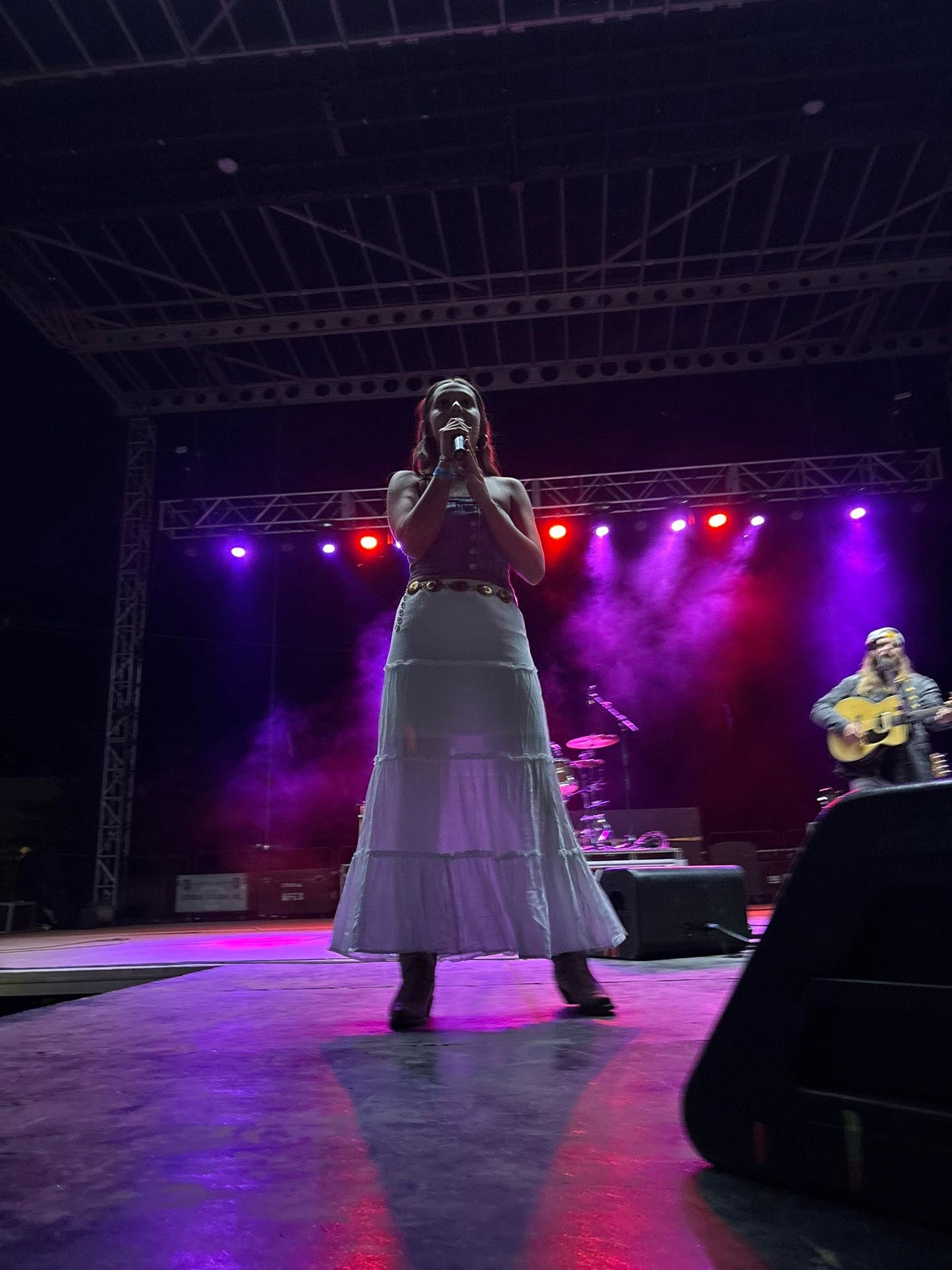 Eva singing under stage lights